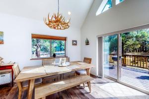 a dining room with a wooden table and a window at Rosewood in Pagosa Springs