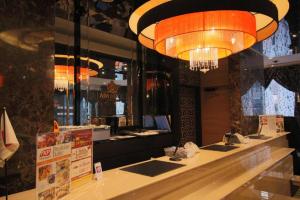 a restaurant with a chandelier hanging over a counter at APA Hotel TKP Nippori Ekimae in Tokyo