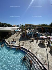 a swimming pool in a resort with people in it at DiRoma Fiori Caldas Novas - YMT - 256 in Caldas Novas