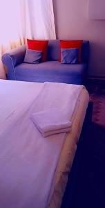 a bed and a couch in a room at Thully Teams in Nelspruit