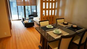 a dining room with a table and chairs and a living room at Machiya no Yado / Vacation STAY 24402 in Kyoto