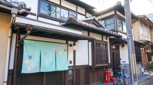 a building with a banner on the front of it at Machiya no Yado / Vacation STAY 24402 in Kyoto