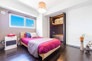 a bedroom with a large bed and a closet at DIVA in Sapporo +40 photos