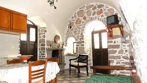 a kitchen with a stone archway in a room at Karampela Despina in Mestá