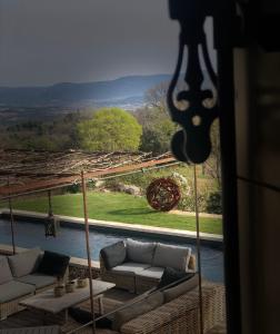 a living room with couches and a view of a river at Une Sieste en Luberon in Bonnieux