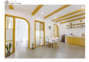 a living room with a table and a kitchen at LaDa's House Da Nang in Danang