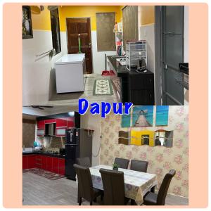 a kitchen with a table and a kitchen with red cabinets at D' Corner Islam Homestay in Kuala Kangsar