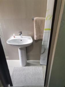 a bathroom with a white sink and a shower at Sunset View Palace Guest House in Soshanguve +10 photos