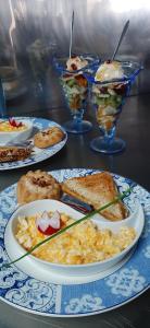 a table topped with plates of food and desserts at Agia Roumeli Hotel in Agia Roumeli