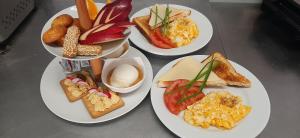 three plates of breakfast foods on a table at Agia Roumeli Hotel in Agia Roumeli