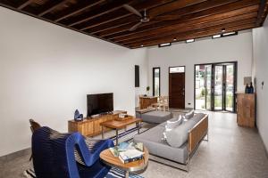 a living room with a couch and a table at Baan Kamana Guest House in Phangnga
