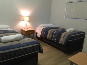 Mandurah Ocean Marina Chalets tesisinde bir odada yatak veya yataklar