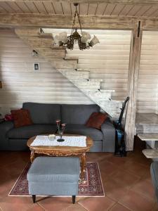 a living room with a couch and a table at Private cottage house near Ljubljana in Šentvid pri Stični