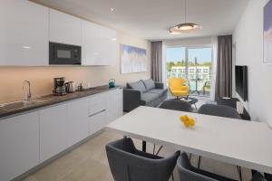 a kitchen and living room with a table and chairs at Maj Luxury Residence in Poreč
