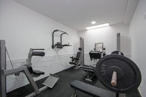 a gym with several tread machines in a room at Stella Maris in Promajna