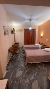 a hotel room with two beds and a ceiling at Hotel Cosmos in Athens