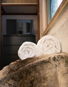 a pair of towels sitting on the back of a bed at The Nest - A High Altitude Hideaway in Crackenback
