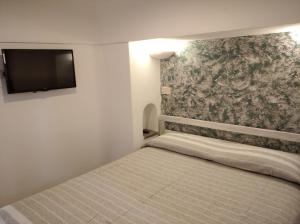 Postel nebo postele na pokoji v ubytování Dammuso U Sarduni