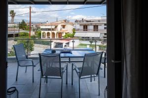 a patio with a table and chairs on a balcony at Oreon Suites - Usia in Nafplio