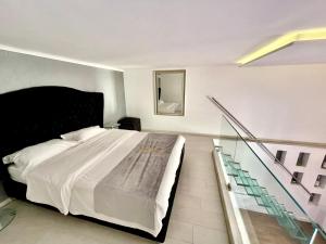 a bedroom with a large bed and a staircase at Jacuzzi Andrassy Avenue in Budapest