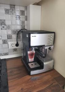 a coffee machine with a cup on top of it at Modern Room With A Great Sunrise in Timişoara
