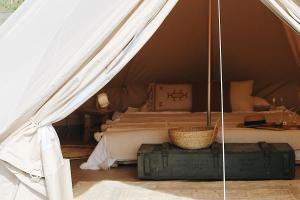 a bedroom with a tent with a bed and luggage at Bell Tent Parc Bûten Jubbega in Jubbega-Schurega