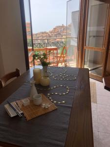 a table with a blue table cloth with vases on it at Appartamento “BellaVista” a Norma in Norma