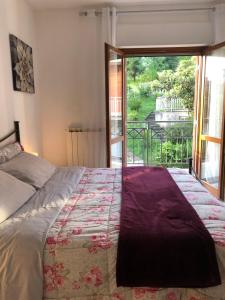 a bedroom with a bed and a large window at Appartamento “BellaVista” a Norma in Norma