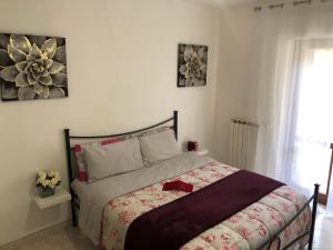a bedroom with a bed with a red bow on it at Appartamento “BellaVista” a Norma in Norma