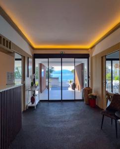 a lobby with a view of the ocean at Hotel l'Isolella in Porticcio