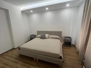 a bedroom with a bed and two night stands at B&B DEA Gela in Gela