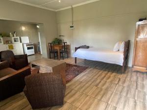 a bedroom with a bed and a living room at Klipfontein Farm House in Molteno