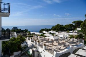 an aerial view of a resort with umbrellas and the ocean at La Residenza Capri in Capri