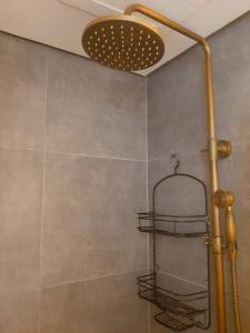 a shower with a shower head and a shower at StayPlus Tagaytay London Suite 50MBPS WIFI+parking in Tagaytay