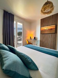a bedroom with a bed with a view of the ocean at Hotel l'Isolella in Porticcio