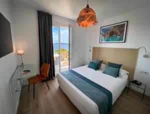 a hotel room with a bed and a balcony at Hotel l'Isolella in Porticcio