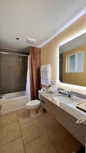 a bathroom with a sink and a toilet and a tub at Yosemite View Lodge in El Portal