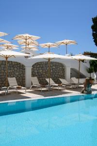 a swimming pool with chairs and umbrellas and a pool at La Residenza Capri in Capri