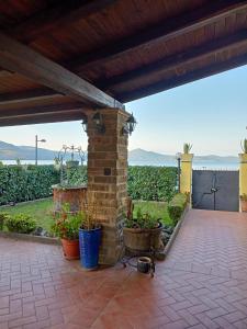 eine Terrasse mit einem gemauerten Kamin und Blick auf einen Weinberg in der Unterkunft la casa in riva al lago in Bracciano