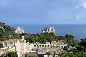 a view of a building with mountains in the background at La Residenza Capri in Capri