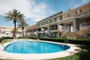 a swimming pool in front of a building at Townhouse with terraces and communal pool in Gandía