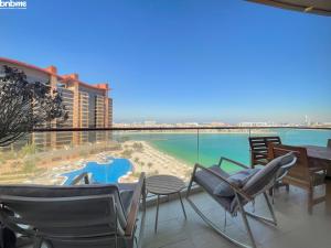 a balcony with chairs and a view of the water at bnbmehomes - Look over the Palm and Sea from Every Room - 504 in Dubai