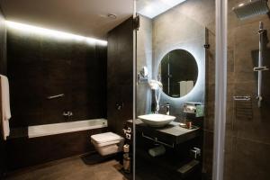 a bathroom with a sink and a toilet and a shower at Holiday Inn Telavi, an IHG Hotel in Tʼelavi