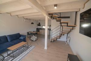 a living room with a blue couch and stairs at Baltic Breeze in Władysławowo