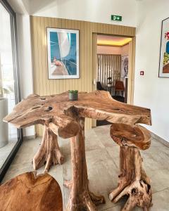 a table made out of tree stump logs at Hotel l'Isolella in Porticcio