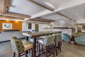 a dining room with a long table and chairs at The Encinitan Hotel & Suites in Encinitas