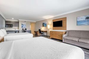 a hotel room with a bed and a couch at The Encinitan Hotel & Suites in Encinitas +32 photos