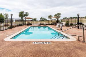 a swimming pool with a fence around it at Days Inn & Suites by Wyndham Mineral Wells in Mineral Wells