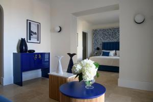 a room with a vase of flowers on a table at La Residenza Capri in Capri