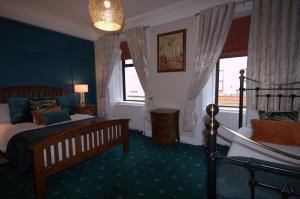 a bedroom with a bed and a window at Lizzys Little Kitchen Town Accommodation in Listowel